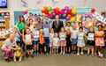 Photo of a group of kids holding up their Summer Reading Challenge certificates