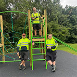 Photo of Grounds Staff alongside the new item of play equipment on Meade Park