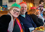 Photo of people enjoying Christmas dinner together