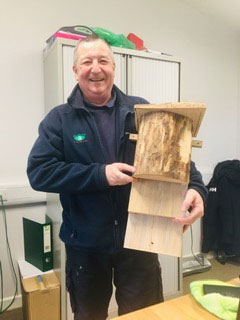 Photo of Tim Hewer holding a Kent Bat Box